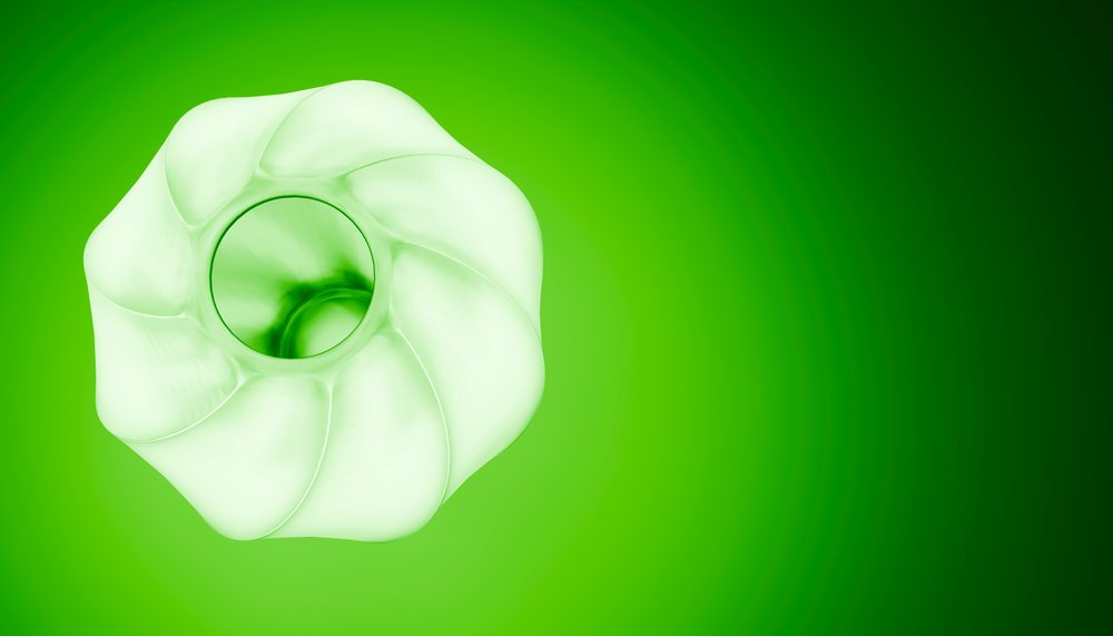 Abstract white twisting sculpture on a gradient green background in studio lighting.