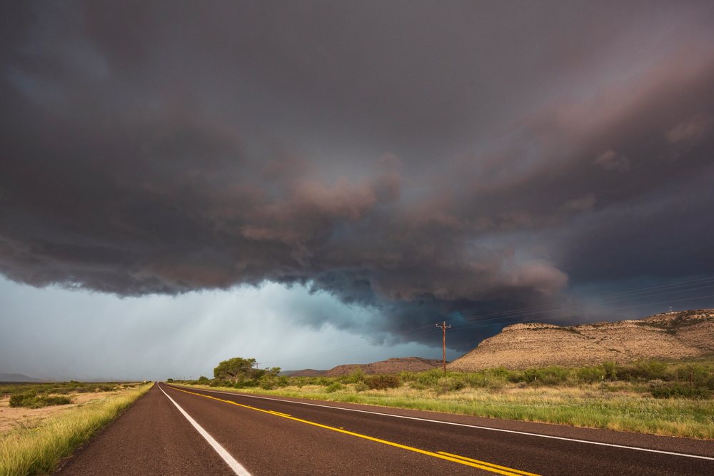 Storm clouds and rain approach along TX Highway 90, in the USA's Great Plains region, Sanderson.