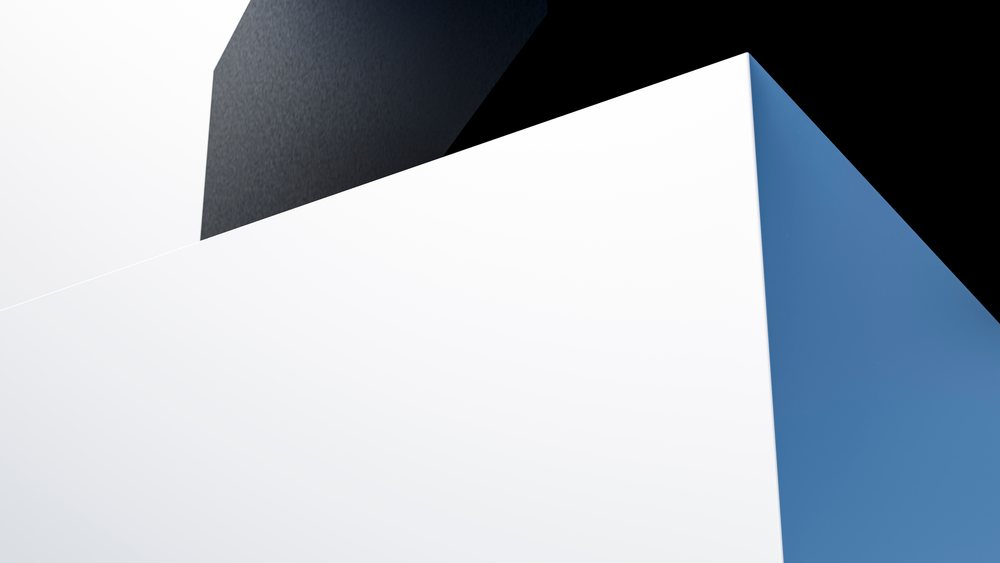 Abstract geometric composition of white, black, and blue blocks with sharp edges, clean lines, and studio lighting highlighting smooth surfaces in a modern minimalist design.