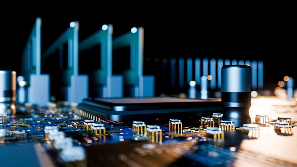 Close-up of a circuit board showing a microchip and capacitors.