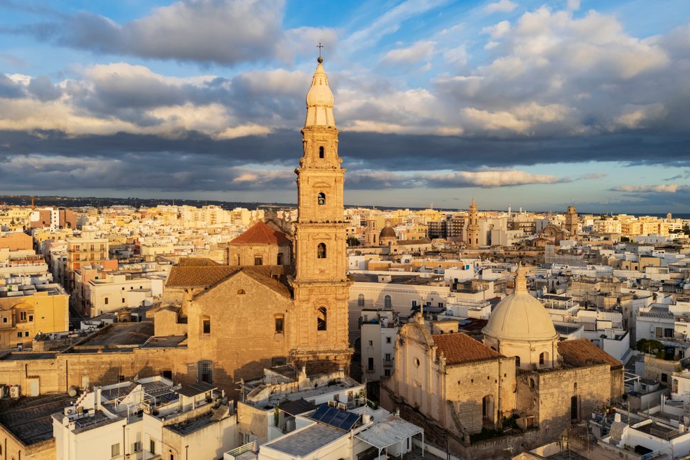 Historic stone cathedral basilica with tower and dome, Monopoli, Puglia, Italy.