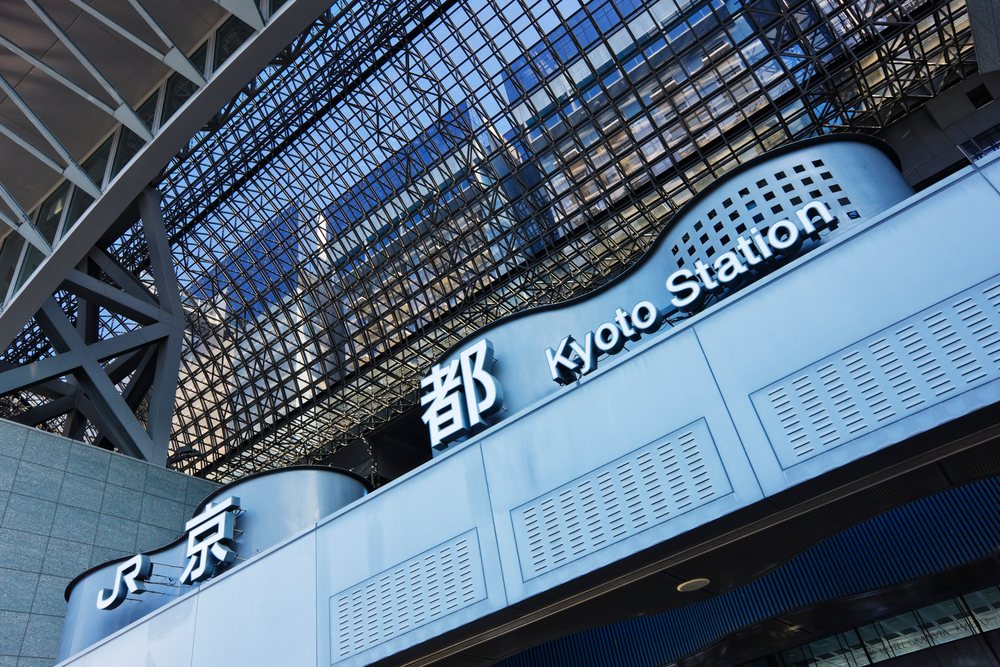 Modern Kyoto Station's steel and glass structure with JR signage, serves as a major urban transport hub, Honshu, Japan.