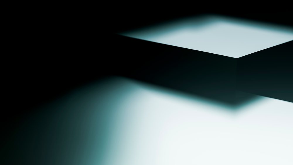 Rectangular shadow casts a dark silhouette on a light surface in an abstract minimalist composition with high contrast.