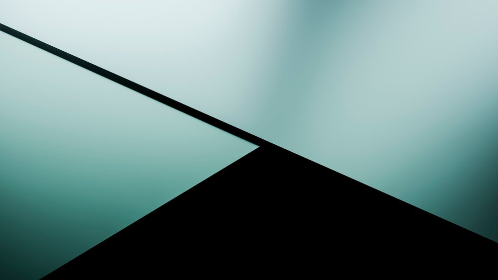Two large blue and one black triangular shapes form a sharp, abstract geometric pattern with smooth gradient blue hues.