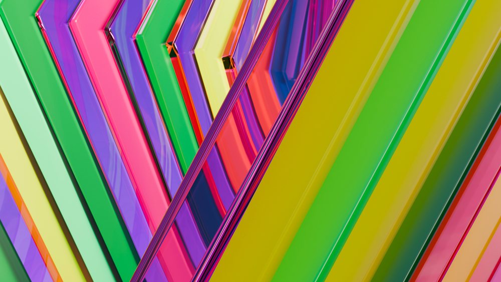 Colorful diagonal geometric pattern featuring reflective plastic shapes forming a vibrant abstract design.