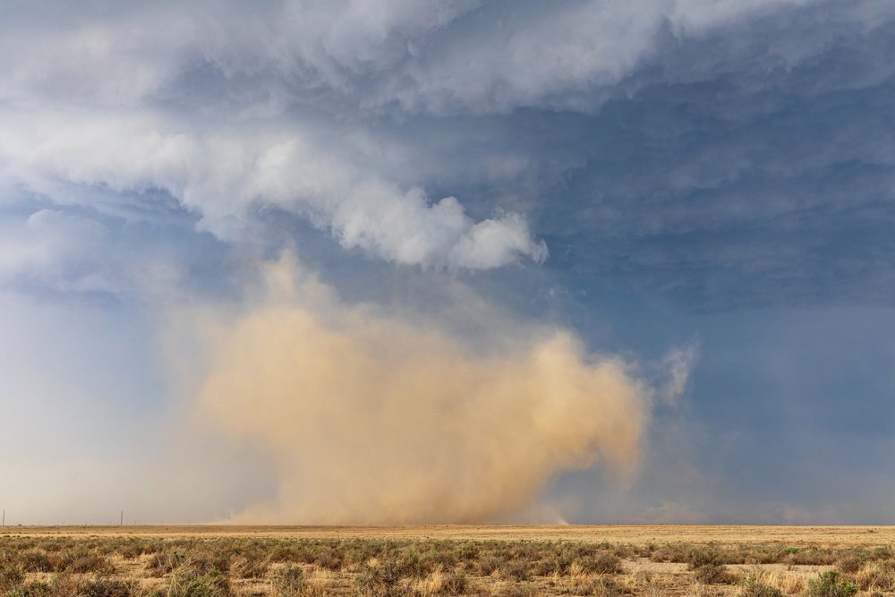 Land spout tornado over dry prairie on County Road 2, kicking up a large dust cloud under a stormy sky, Storm Chasing, Weather, Environment, Fowler, Colorado, USA.