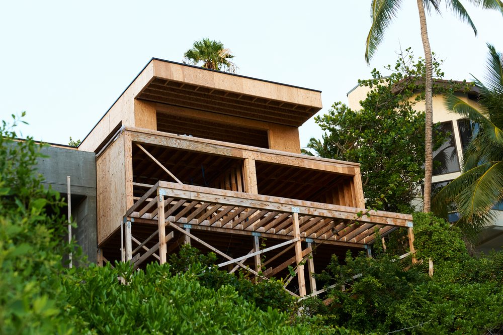 House under construction showing wood framing with attached deck, Oahu, Hawaii, USA.