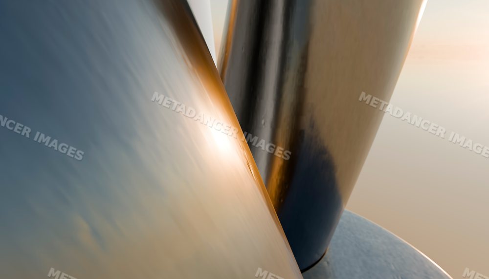 Close-up of smooth reflective curved metal surfaces with warm light