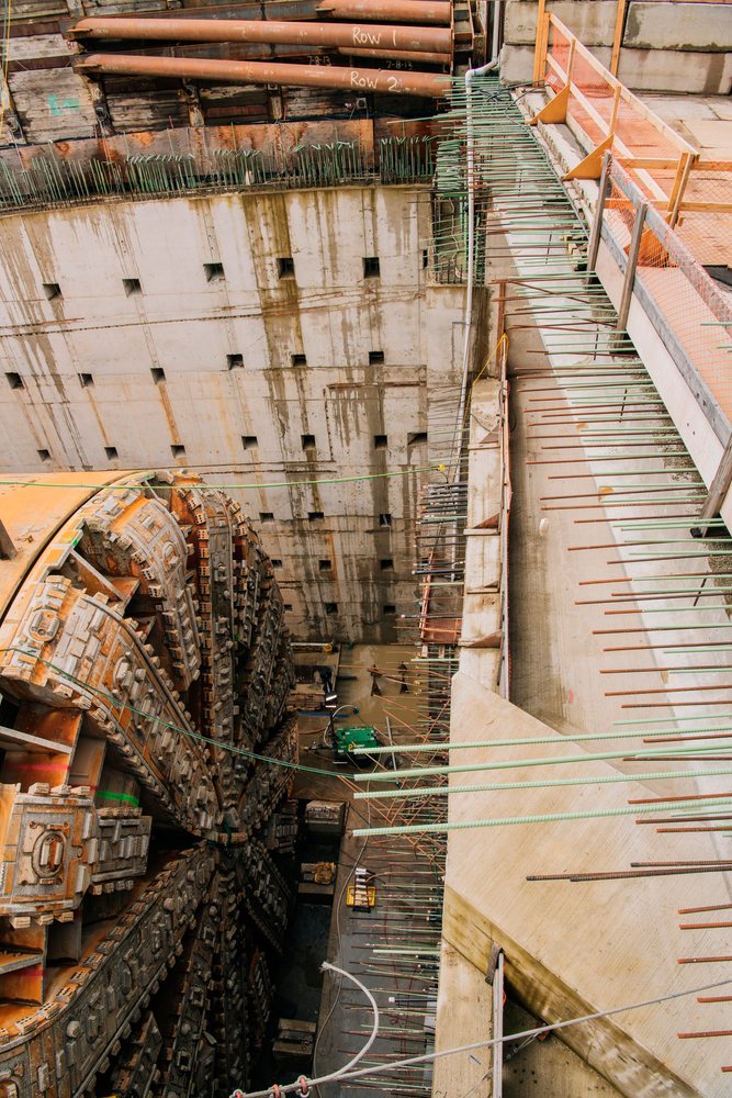 A tunnel boring machine is set up in a large excavation site under construction for a tunnel project, Bertha, drilling, USA.