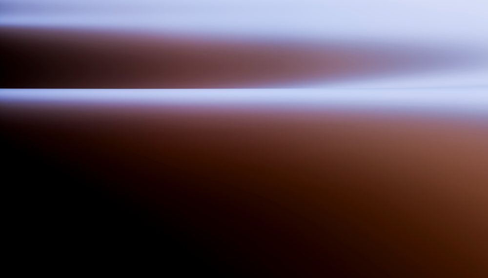 Gradient image with a horizontal line separating brown and blue tones in a smooth abstract design.