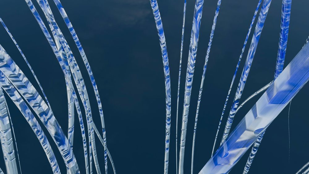 Blue and white translucent twisting tubes forming an abstract decorative sculpture with fluid and reflective design.