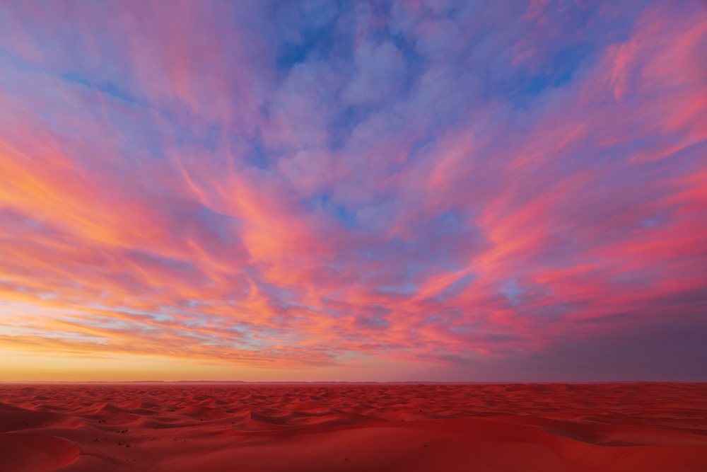 Sunrise at Chaggaga Sand Dunes in Morocco showing colorful sky and desert landscape, Lifestyle, Landscape, Culture.