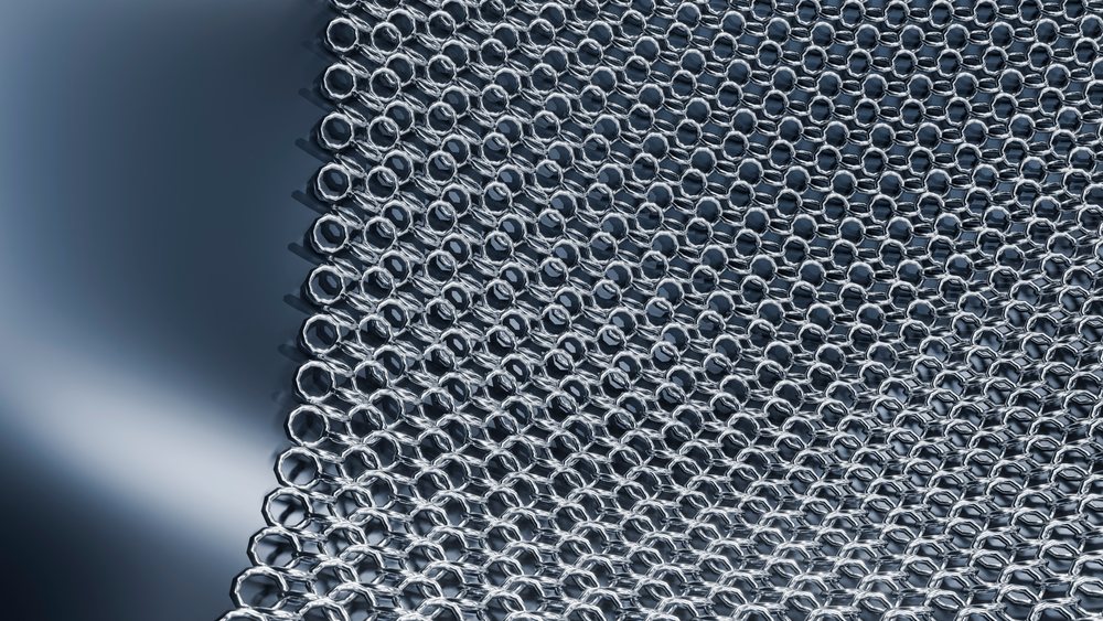 Close-up of hexagonal metal nuts arranged in a pattern on a metal surface.