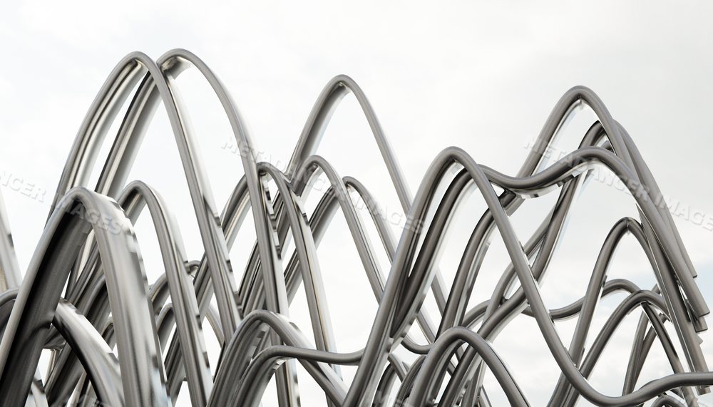 Abstract metal sculpture of curved steel tubes creating interwoven