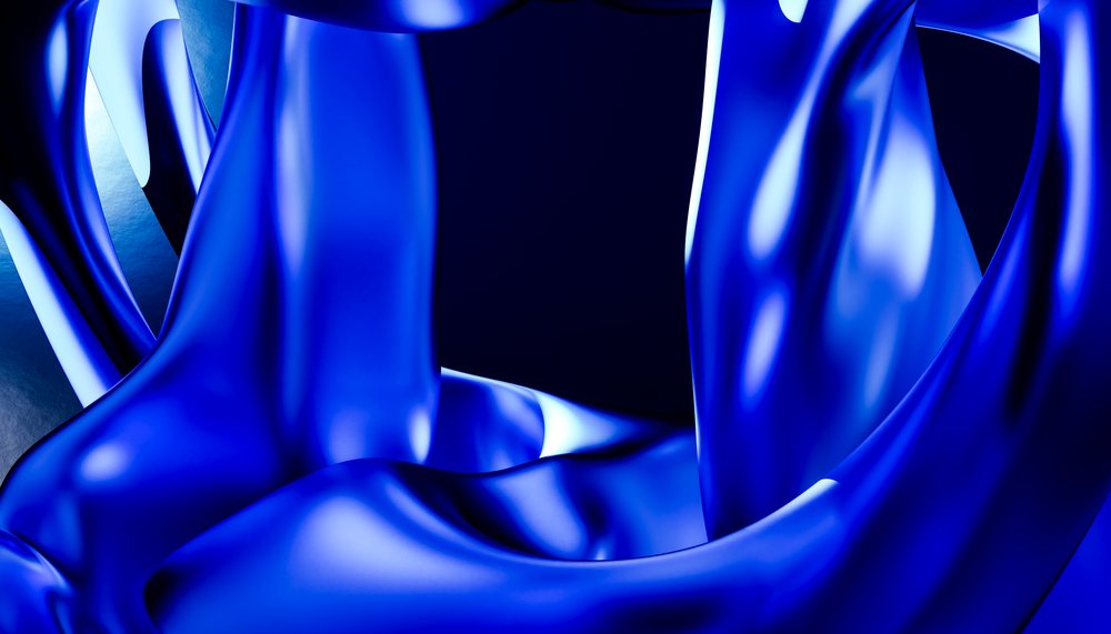 Blue shiny fabric with smooth draping and folds creating an abstract luxurious texture.