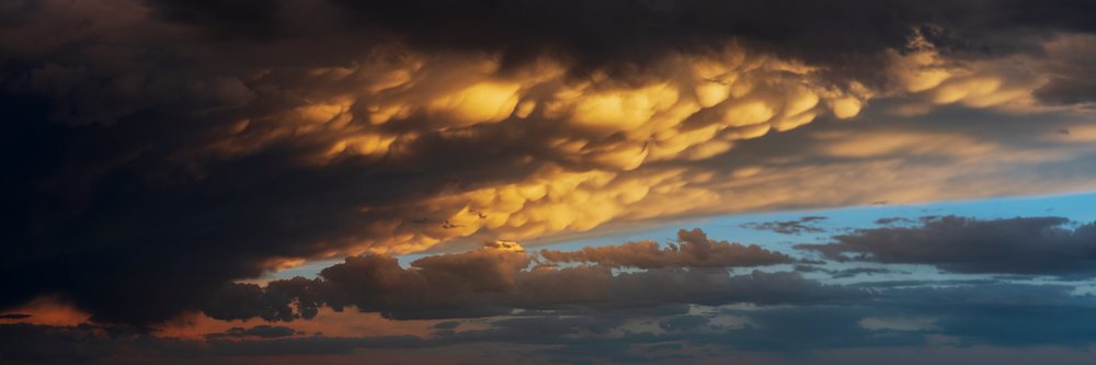 Mammatus clouds illuminated by Sunset glow above the plains, creating a dramatic stormy sky, Storm Chasing, Weather, Environment, Post, Texas, USA.