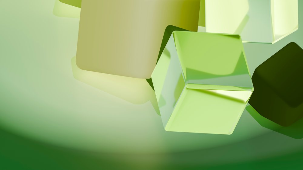 Glossy green and yellow cubes in a modern abstract digital 3D illustration with smooth reflective surfaces.