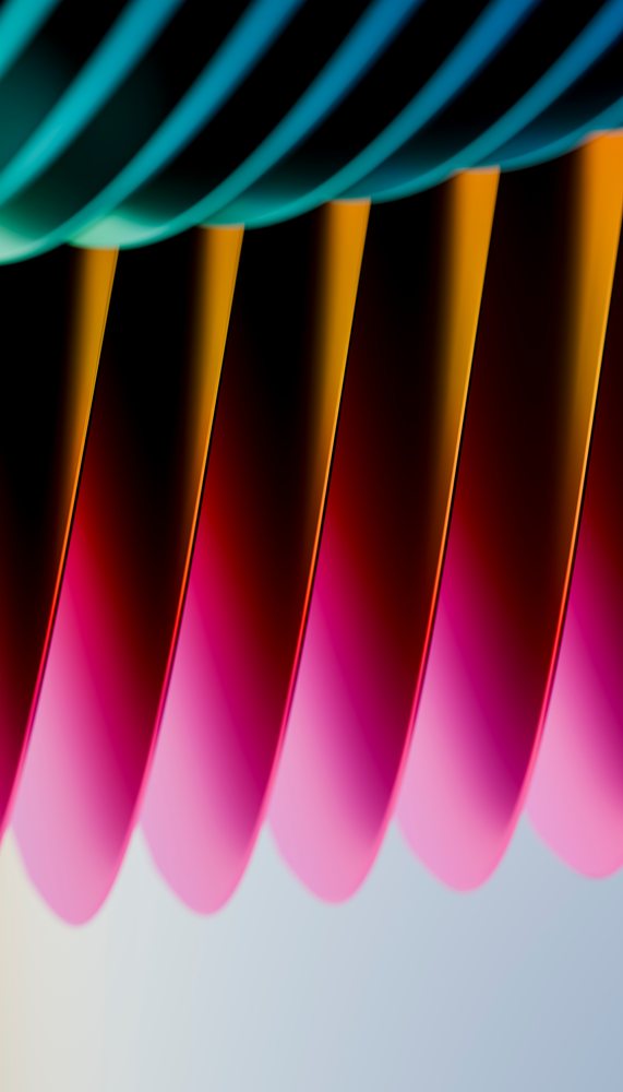 Colorful stack of pink, orange, and blue paper sheets arranged in an abstract artistic pattern with curved edges and gradient colors.