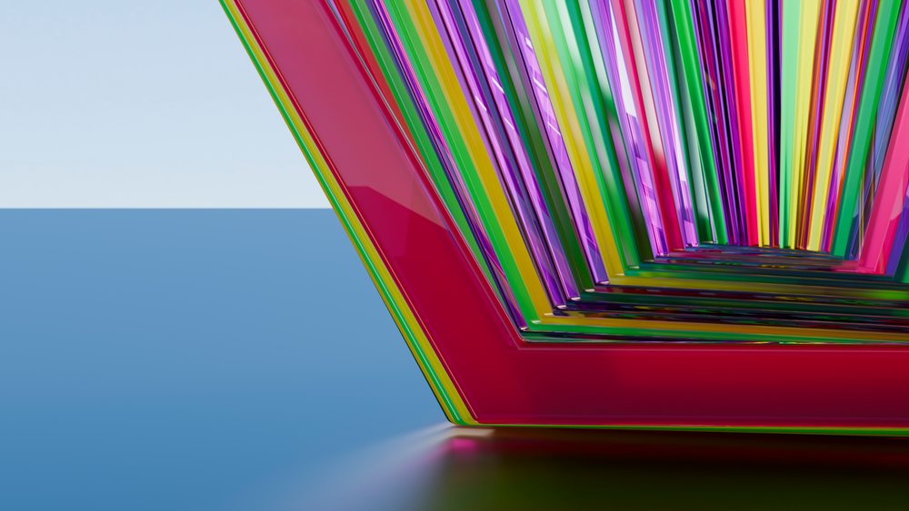 Digital illustration of shiny triangular shapes in a repeated colorful geometric pattern showing a vibrant spectrum with reflective surfaces.
