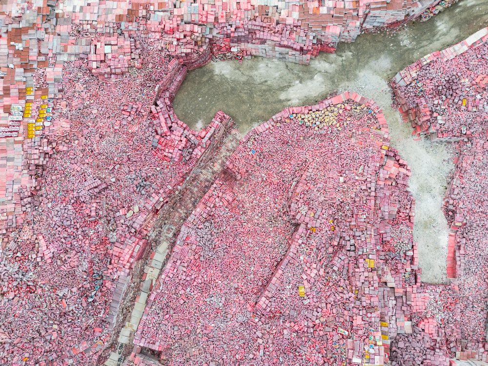 Aerial view of Jiana Mani City in Kham Tibet showing pink rooftops and organized urban layout with distinct city blocks and road patterns, Xinzhaia, Qinghai Province, People's Republic of China.
