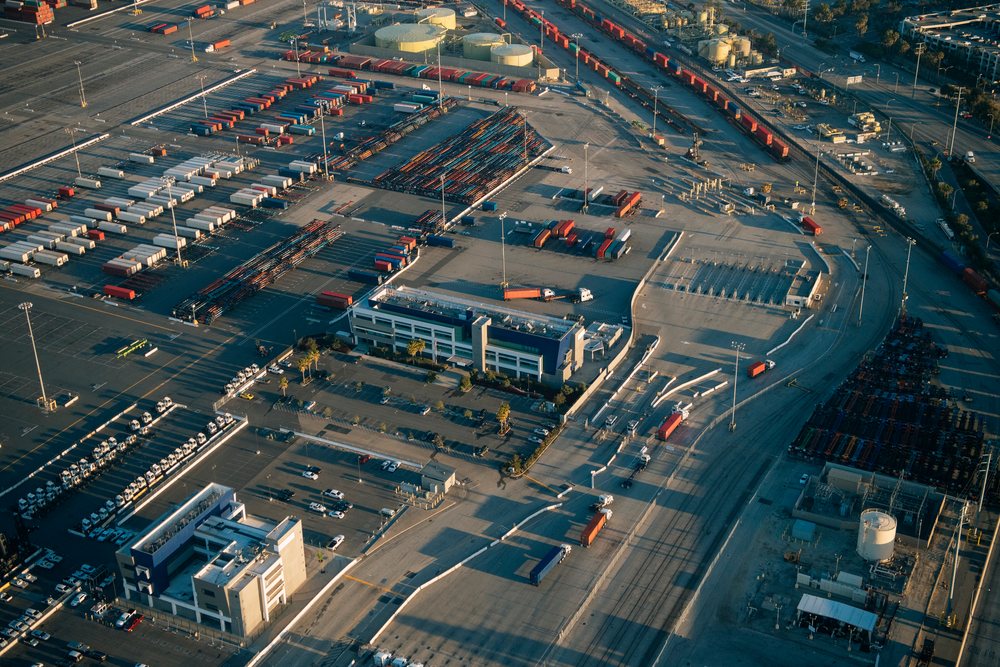 Aerial view of container storage, trucks, and warehouses in the Port of Long Beach, California, CA, USA.