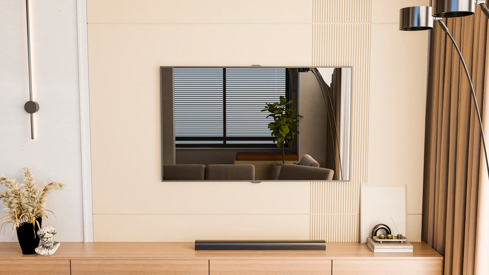 Wall mounted smart TV centered above a wooden cabinet with decorative objects in a modern living room.