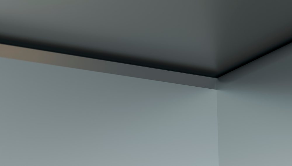 Corner of a gray wall and ceiling in a minimalist interior.
