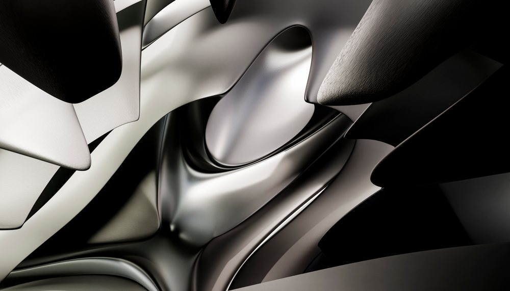 Close-up view of abstract, curved metallic surfaces creating a modern sculptural design in a studio setting.