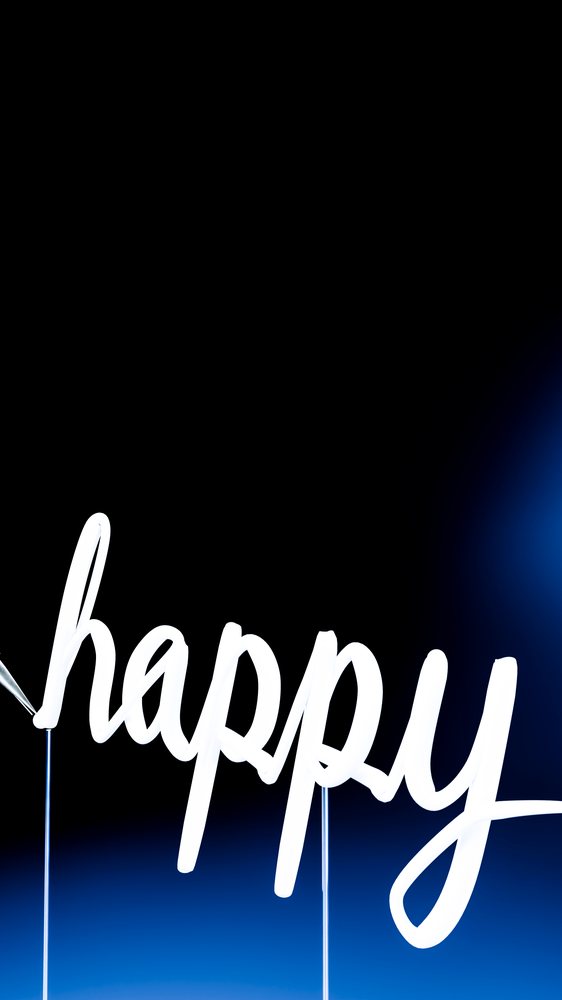 The word "happy" is handwritten in white brush ink on a black background with a blue gradient.