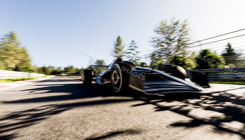 Racing car speeding on an outdoor race track in sunlight