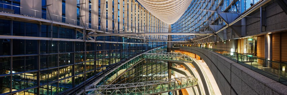 View inside Tokyo International Forum showing its modern glass and steel architecture with multiple walkways, Honshu, Japan.