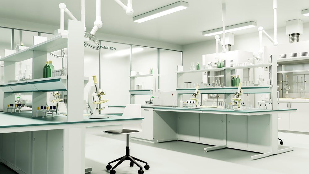 Microscopes, test tubes, and various glassware are arranged on clean laboratory benches in a modern scientific research facility.
