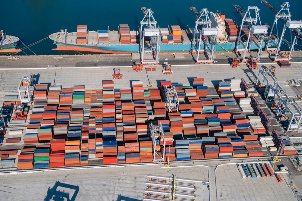 Shipping containers and cargo ship at a container terminal in the Port of Long Beach, lifornia, CA, USA.