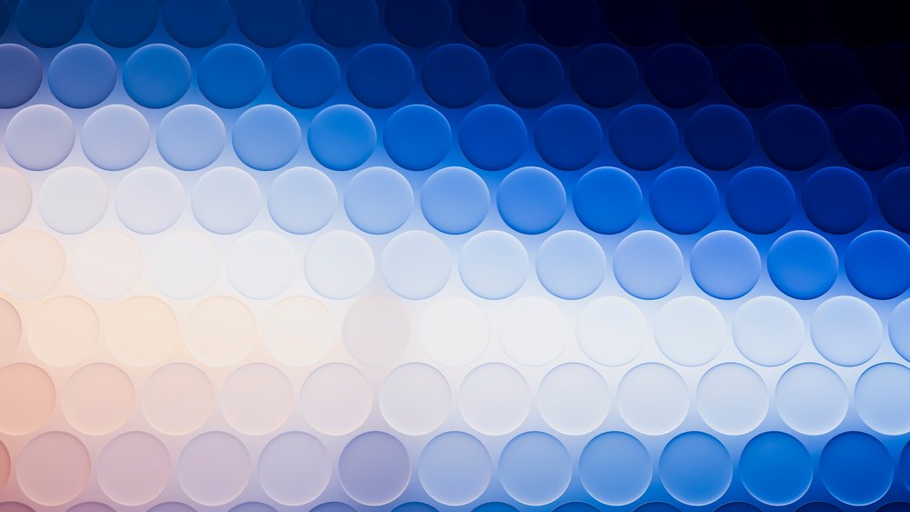 Horizontal rows of matte finish blue circles form a light to dark gradient in an abstract design.