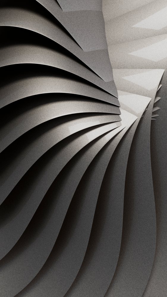 Curved and layered grey paper sheets form a spiral abstract sculpture under soft studio lighting.