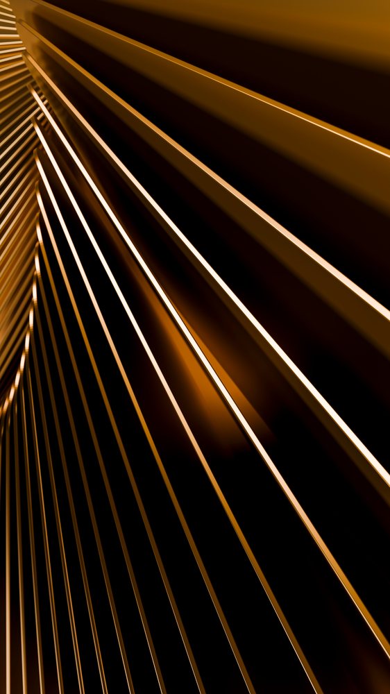 Close-up of golden harp strings on a stringed musical instrument.