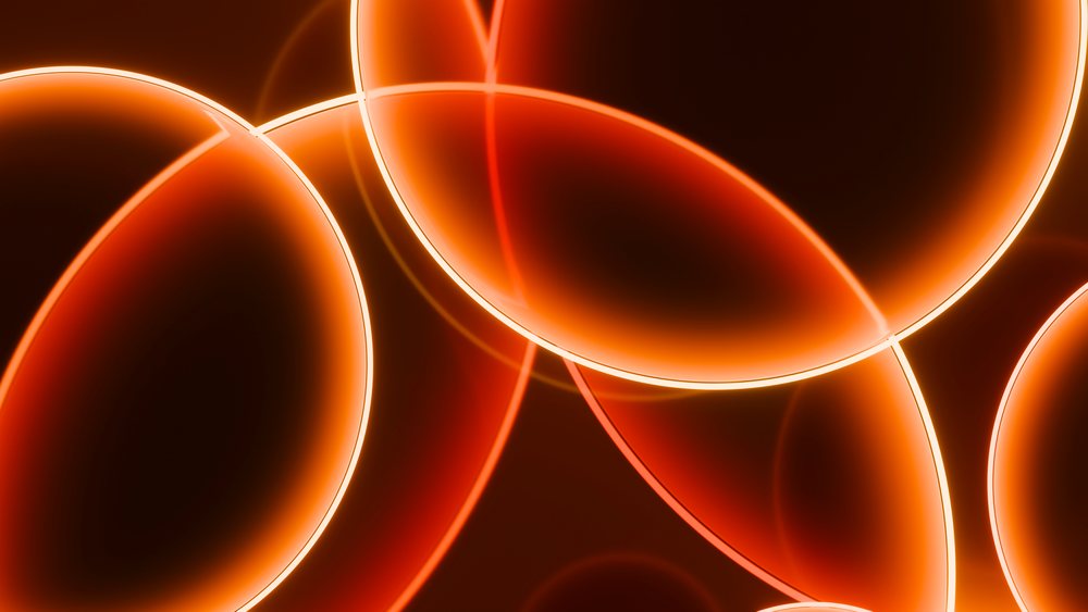 Multiple glowing orange translucent rings overlap on a dark background in an abstract digital illustration.