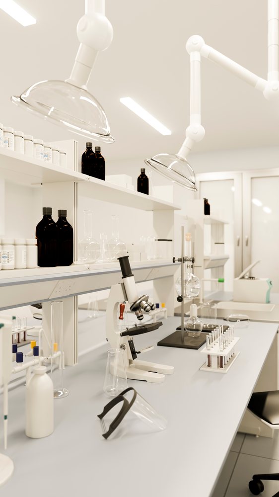 Modern research laboratory bench featuring microscope, test tubes in rack, glass beakers, bottles, and extraction apparatus on white shelves.