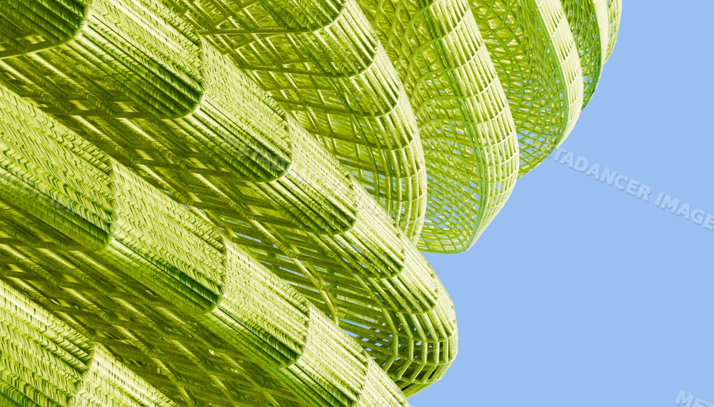 Close-up view of a green abstract woven sculpture outdoors