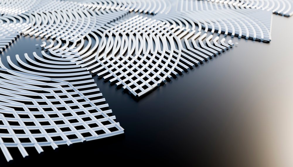 White plastic grids arranged in curved, intersecting patterns on a smooth black surface.