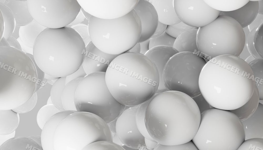 A closeup of glossy white spheres clustered in an abstract composition