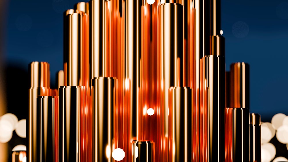 Close-up of vertical golden metal tubes with glowing reflections against a dark background creating a futuristic ambiance.