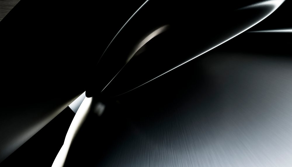 Close-up view of a metal gear wheel showcasing its teeth and surface texture against a dark background.