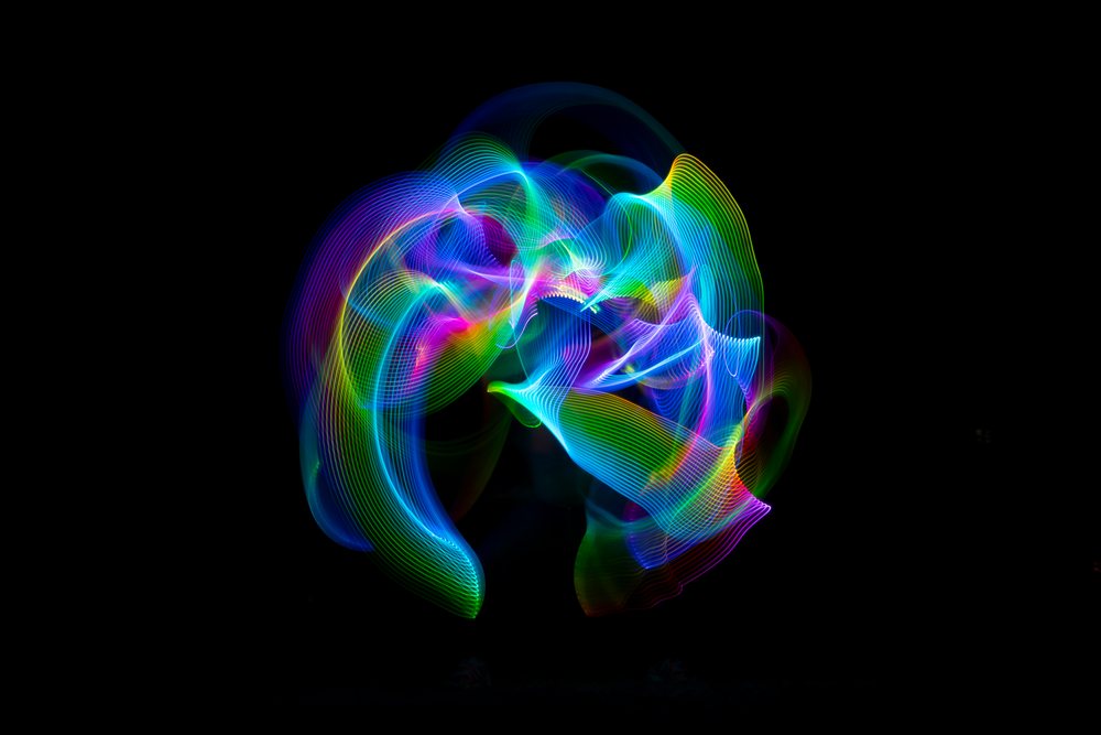 Colorful LED light painting displaying swirling vibrant trails against a dark background, Germany.