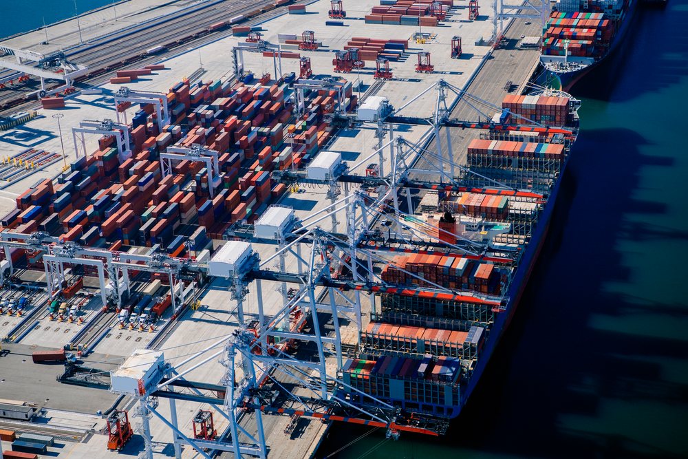 Container ship loaded with cargo containers at a busy shipping terminal in a major port in lifornia, a major port, CA, USA.