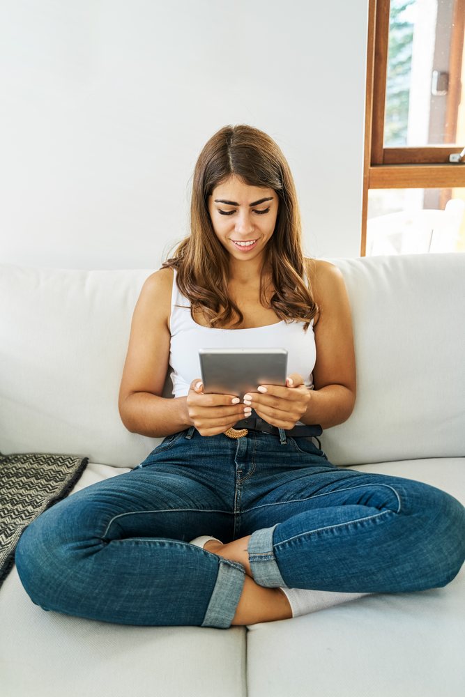 A white woman uses a tablet