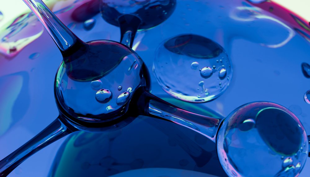 Abstract illustration showing transparent molecular spheres connected by rods with blue and purple light reflections.