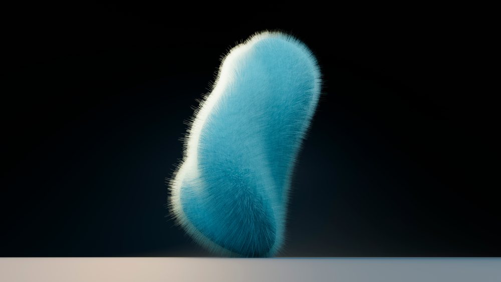 Blue furry abstract shape with soft edges standing on a reflective surface against a dark background under studio lighting.