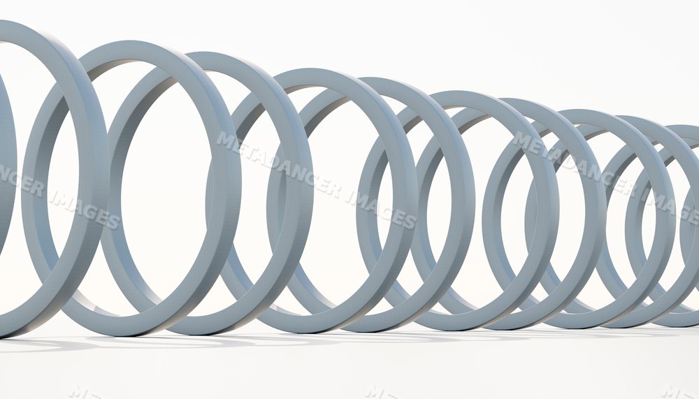 Close-up of a coiled metal spring isolated on a white background