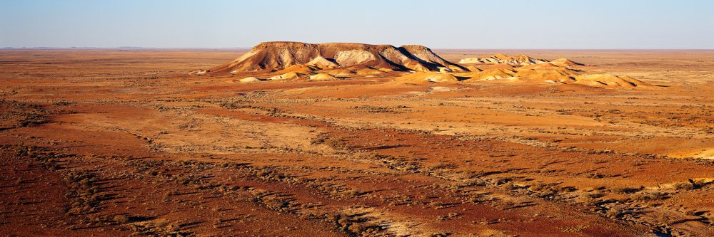 The Breakaways rock formation in an arid desert landscape of South Australia under clear sky.